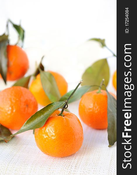 Heap of fresh mandarines with leaves.