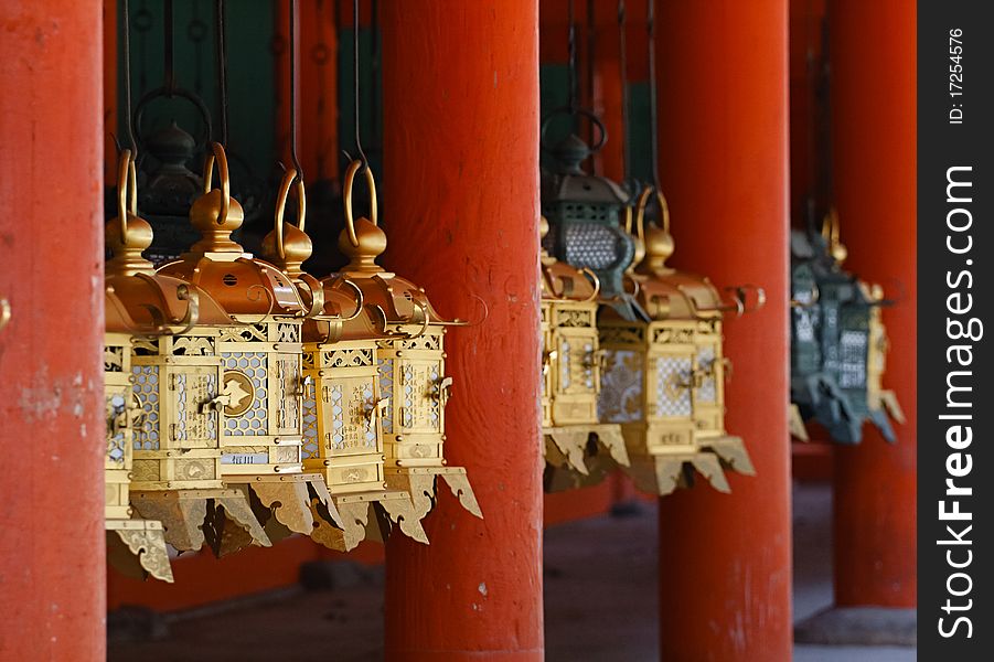 Golden Chinese lantarns hanging on a hooks. Golden Chinese lantarns hanging on a hooks