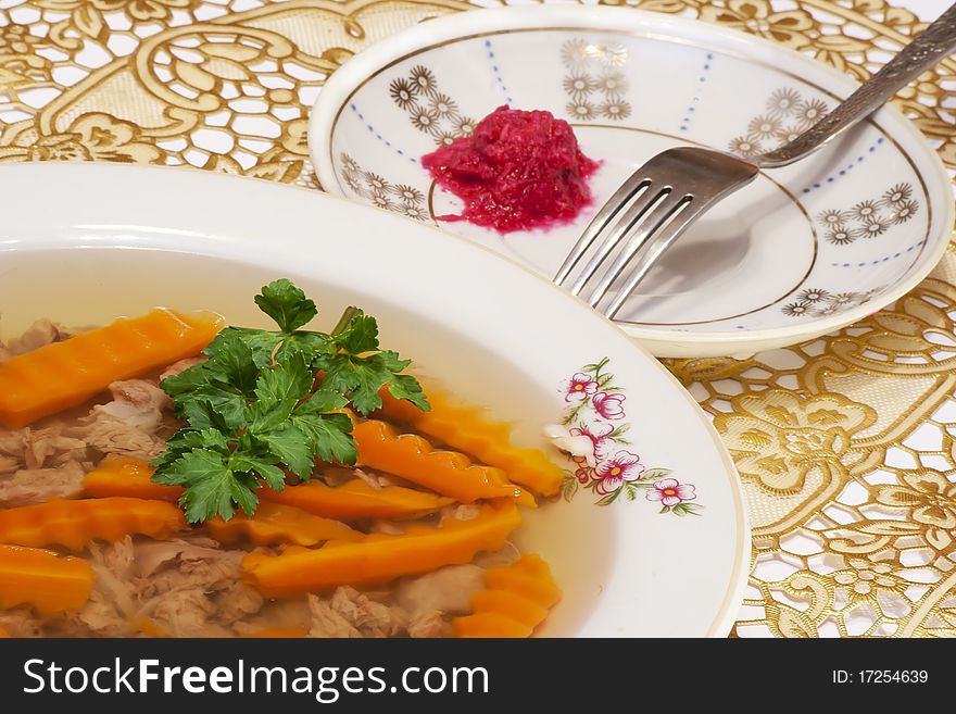 An appetizing jellied minced beef with carrots, garlic and horseradish. Russian cooking. An appetizing jellied minced beef with carrots, garlic and horseradish. Russian cooking