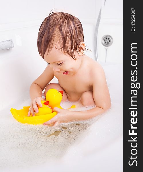 Beautiful little boy taking a relaxing bath with foam. Beautiful little boy taking a relaxing bath with foam