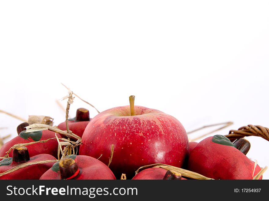 Red apples in a basket with straw and copyspace
