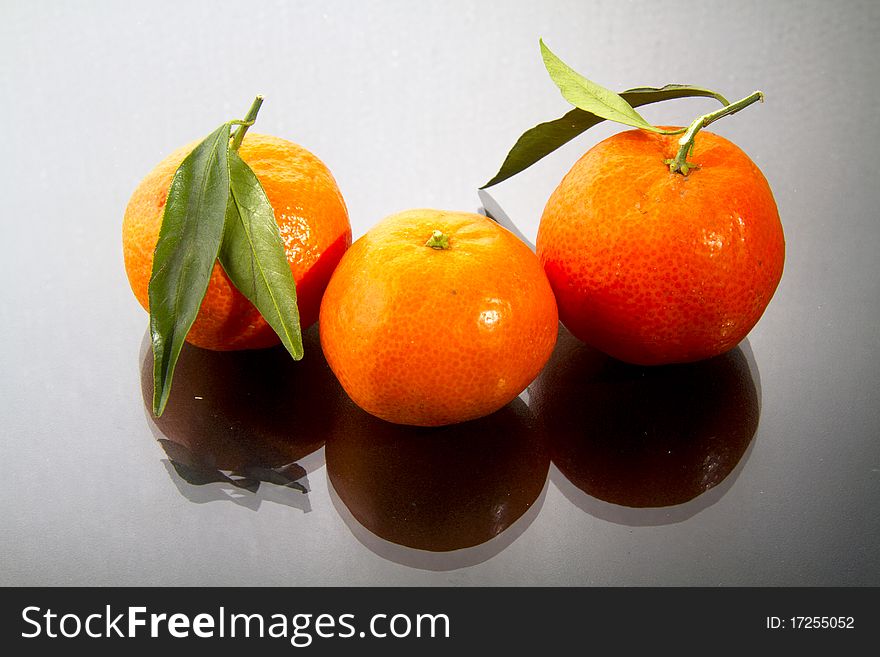 Mandarin oranges isolated on black gloss. Mandarin oranges isolated on black gloss