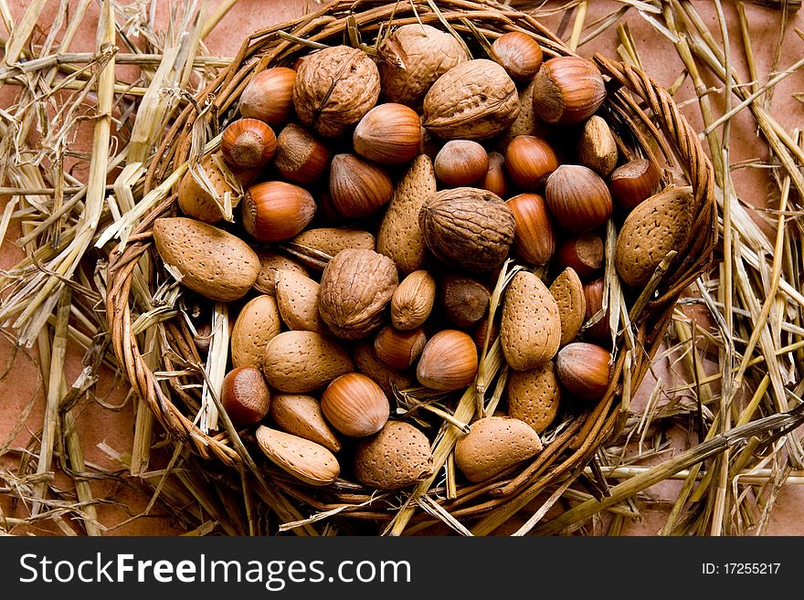 Bunch of nuts in a basket with straw