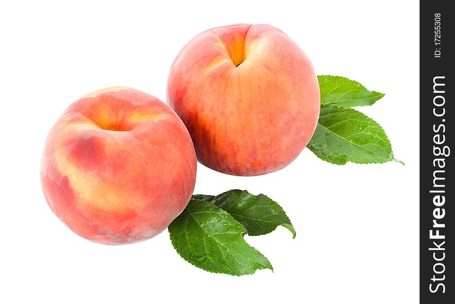 Close-up ripe peaches with leaves, isolated on white