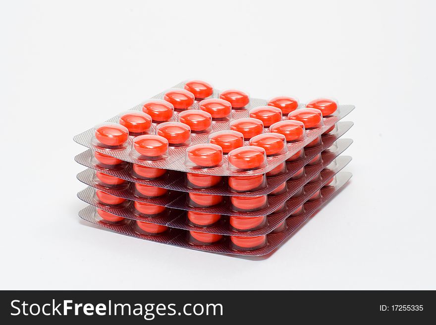 Orange tablets in transparent packing. Orange tablets in transparent packing