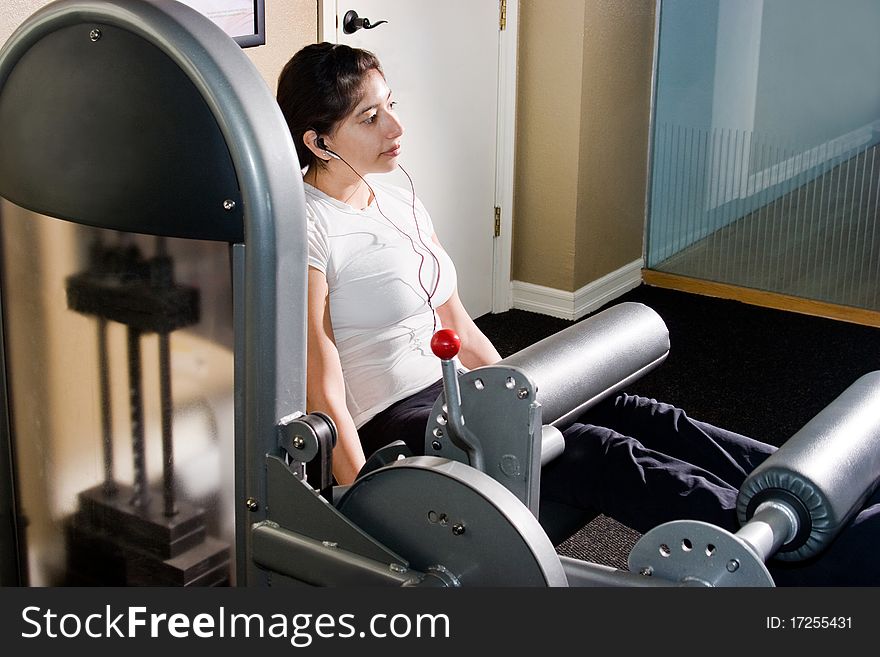 Young woman working out in an indoor gym. Young woman working out in an indoor gym.