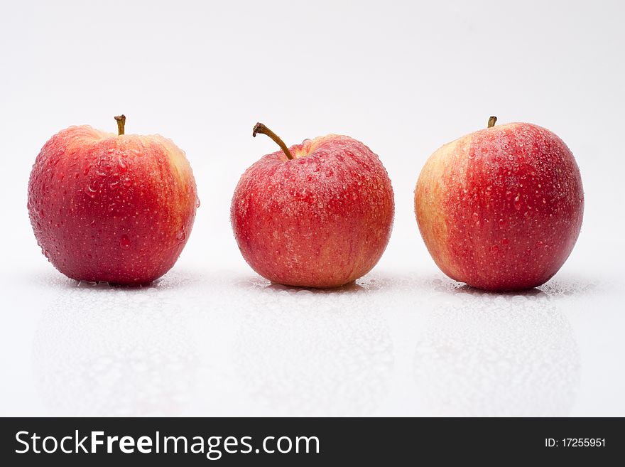 Row of red apples with waterdrops