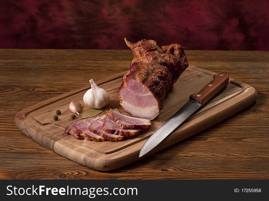 Composition with smoked ham on the table