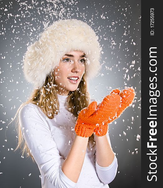 Young beautiful winter girl in bright mittens with snowflakes. Young beautiful winter girl in bright mittens with snowflakes