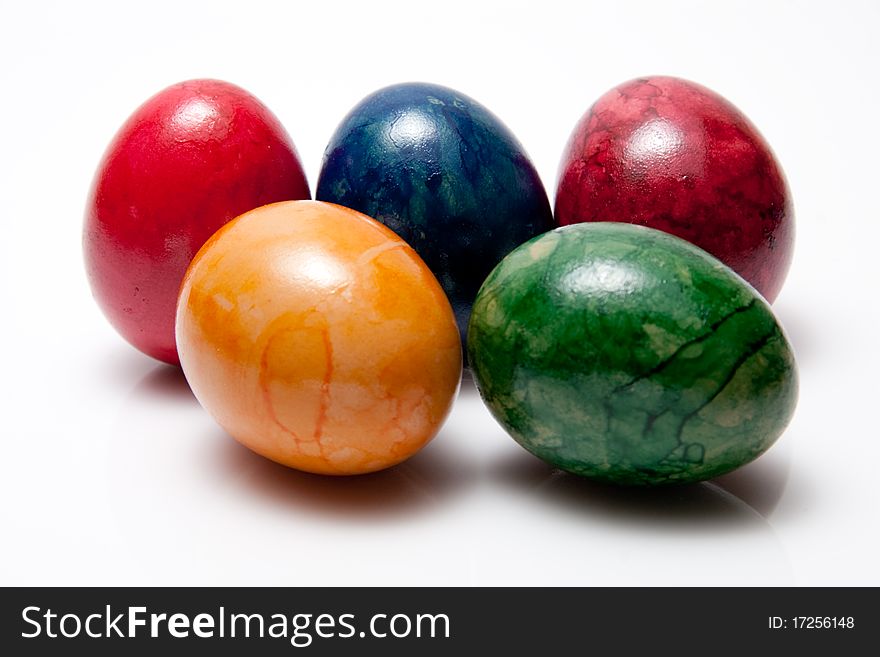 Colored eggs on white background