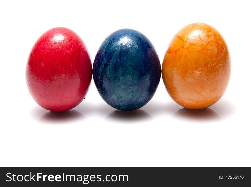 Three colored eggs on white background