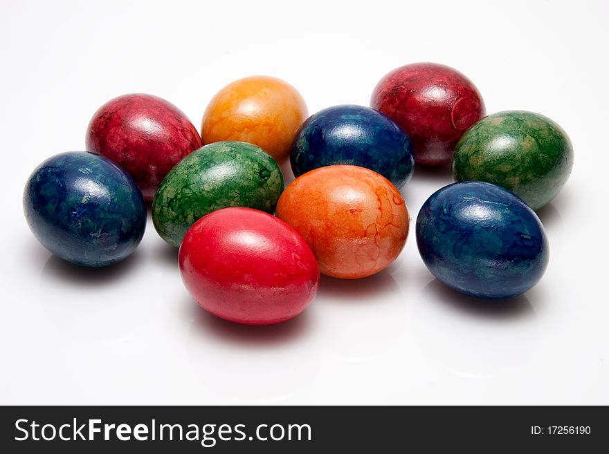 Bunch of colored eggs on white background