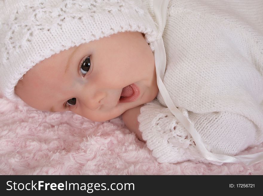 Beautiful two month old baby girl wearing a knitted outfit