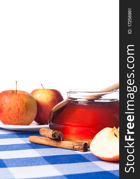 Honey and apples on blue tablecloth