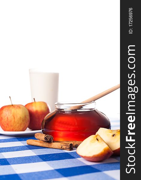 Honey and apples on blue tablecloth