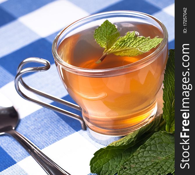 Herbal tea on squares tablecloth