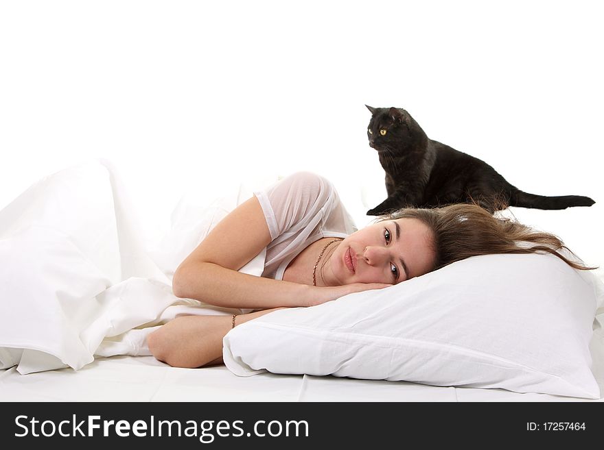 Woman in a bed with her black cat. Woman in a bed with her black cat