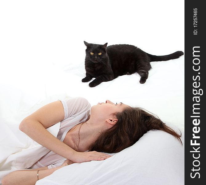 Woman in a bed with her black cat. Woman in a bed with her black cat