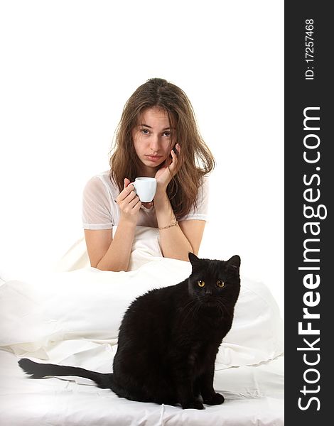 Woman in a bed with her black cat. Woman in a bed with her black cat