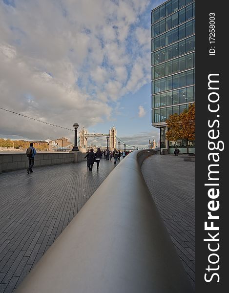 Modern building in london with clouds and the towerbridge in the background