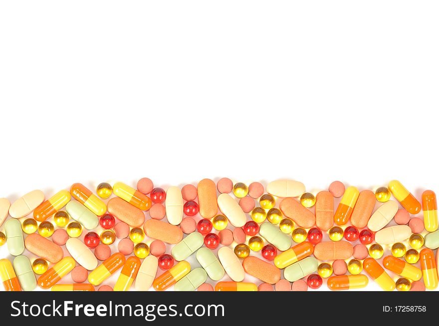 Background from colorful pills on a white background