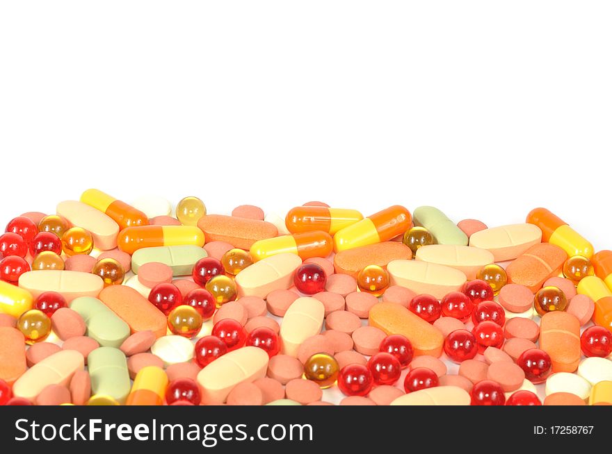 Background from colorful pills on a white background