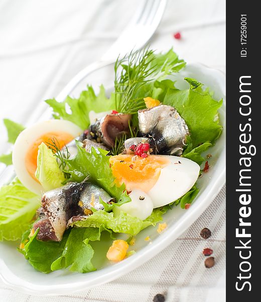 Salad with lettuce, eggs and anchovy on kitchen towel