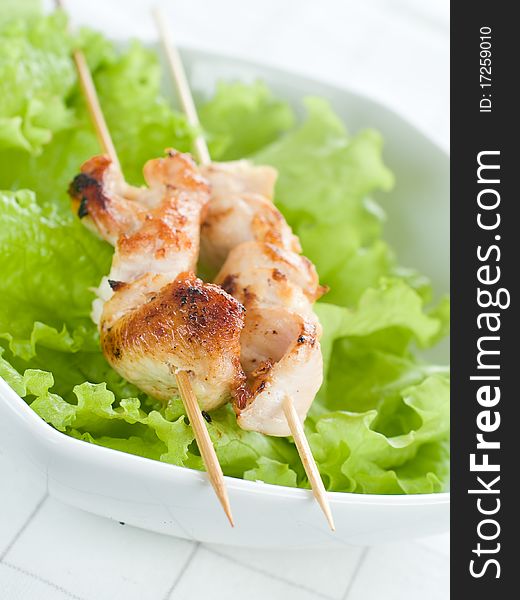 Chicken (or pork) on a grill spit with lettuce