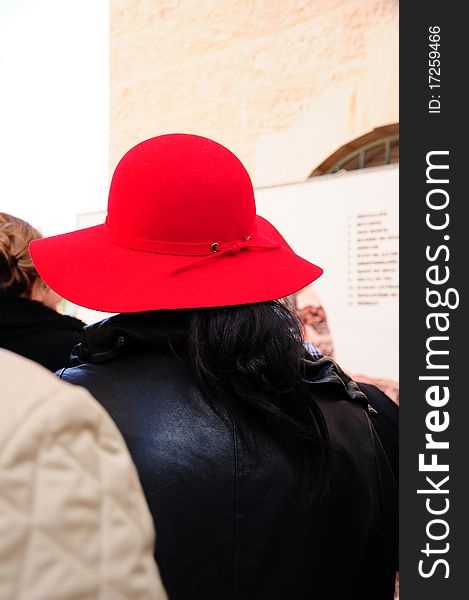 A woman wears red hat