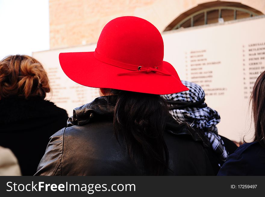 A woman wears red hat