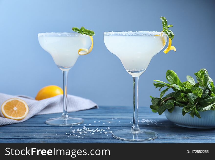 Glasses of tasty Margarita cocktail on wooden table