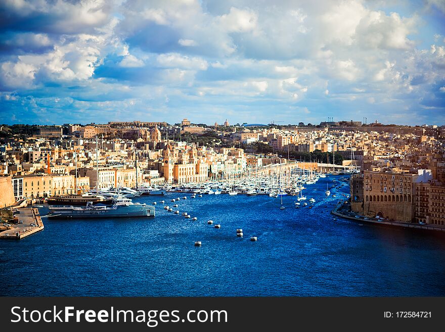 Boats in harbor of Valletta, capital of Malta. Scenic view of maltese coast with ships and traditional houses. Popular famous travel tourism destination island Malta. Sea landscape