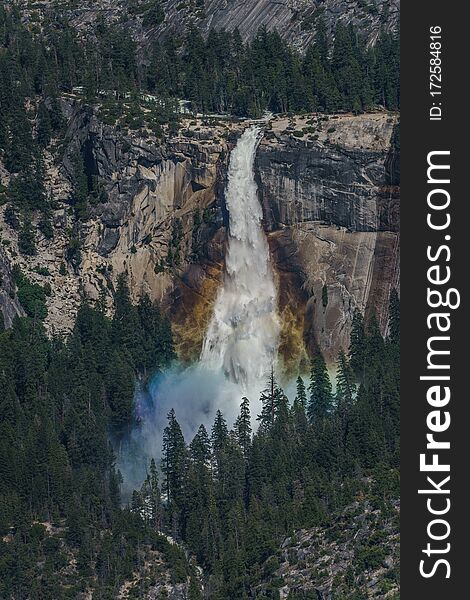 Rainbow in Falls, Yosemite Valley. This beautiful waterfall is found in the glacier valley at Yosemite National Park. Rainbow in Falls, Yosemite Valley. This beautiful waterfall is found in the glacier valley at Yosemite National Park.