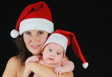Beautiful Mommy Santa And Her Baby Santa Boy Royalty Free Stock Images