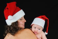 Beautiful Mommy Santa And Her Baby Santa Boy Stock Image