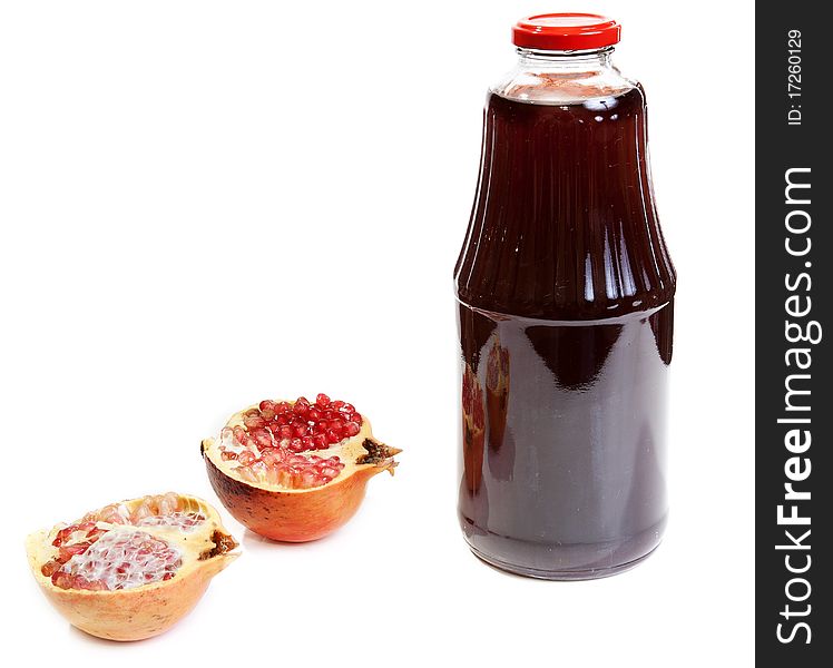 Bottle of juice and ripe piece grenade on white background