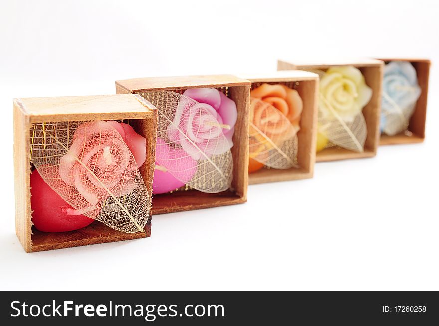 Roses and heart shaped candles in wooden boxes