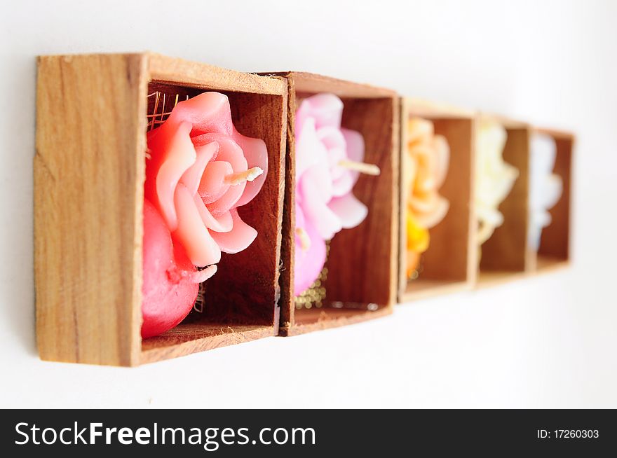 Roses and heart shaped candles in wooden boxes