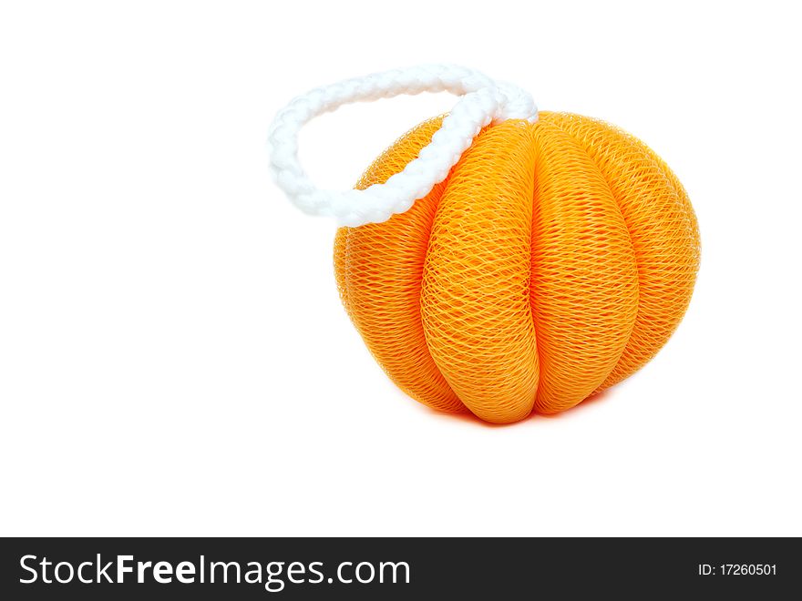 Yellow sponge in the shape of a pumpkin on a white background
