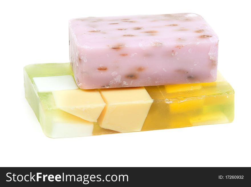 Green and purple fruit soap isolated on white background