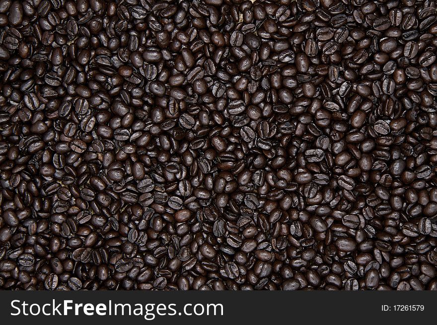 Whole roasted organic coffee beans, evenly displayed as a background.
