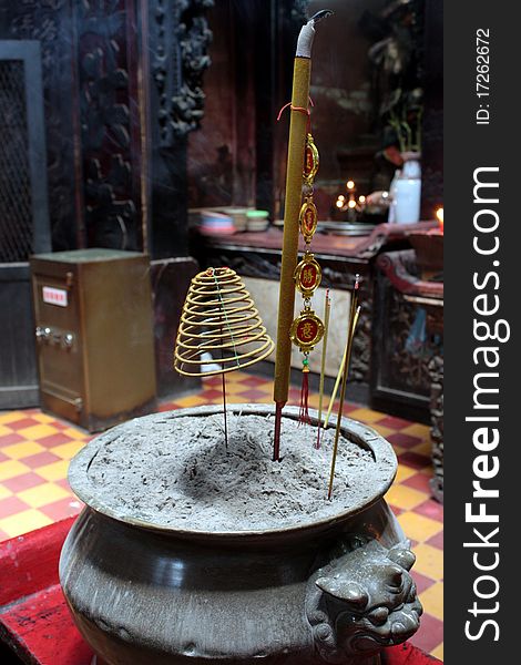 Incensed joss stick burning slowly in an urn in a temple in Vietnam. Incensed joss stick burning slowly in an urn in a temple in Vietnam