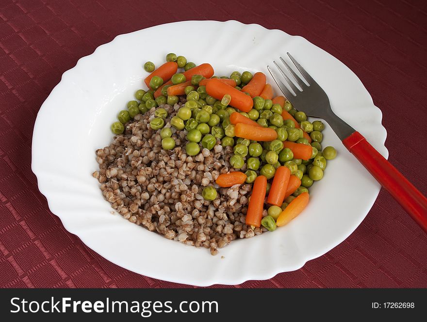 Buckwheatgroats with boiled green peas and baby carrot