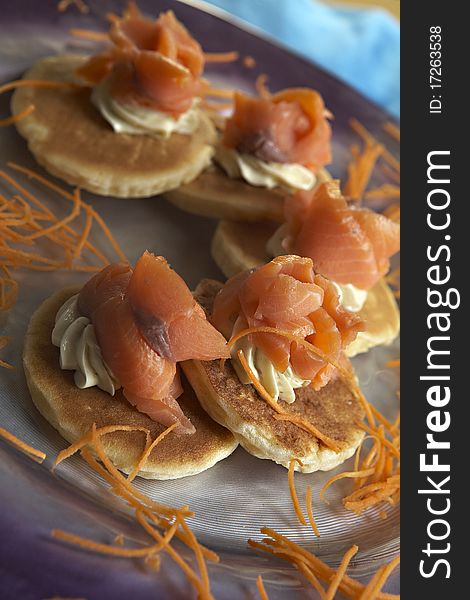 Salmon crepe and carrot on plate