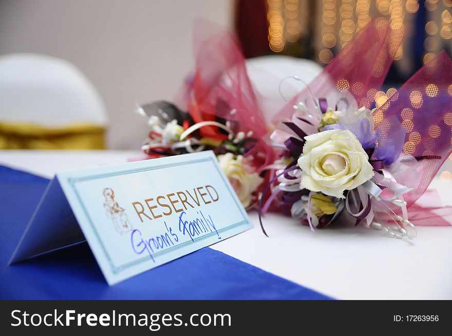 Flowers with a reservation label on a table at a wedding reception. Flowers with a reservation label on a table at a wedding reception