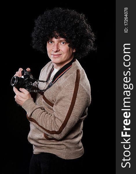 Funny guy with a camera on a black background