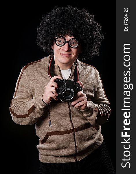 Funny guy with a camera on a black background