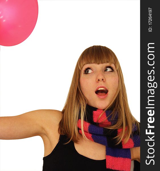 Beautiful blond girl in a pink scarf with black stripes plays with a pink balloon. Beautiful blond girl in a pink scarf with black stripes plays with a pink balloon