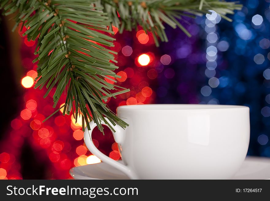 Christmas theme. Motley-colored background with a Christmas tree branch.