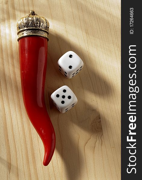 A red horn and two dice. A red horn and two dice